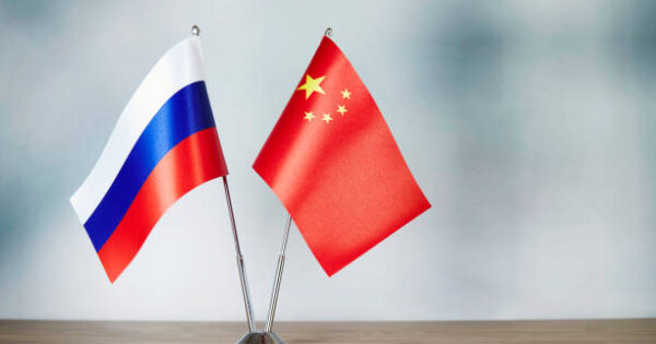 image-chinese-and-russian-flag-standing-on-the-table-with-defocused-background