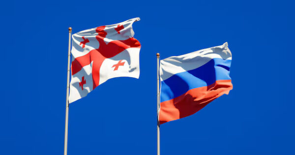 image-beautiful-national-state-flags-georgia-russia-together-blue-sky-3d-artwork_337817-4528